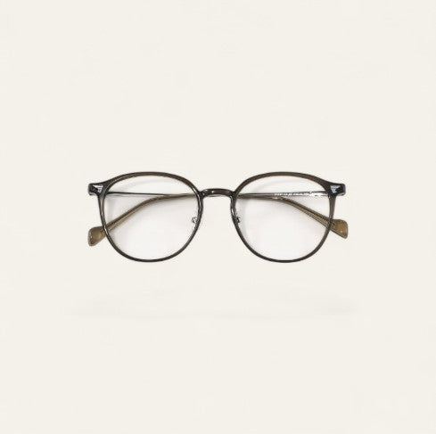 Driftward ultra light blue light blocking glasses with a transparent gray TR90 frame and round lenses.