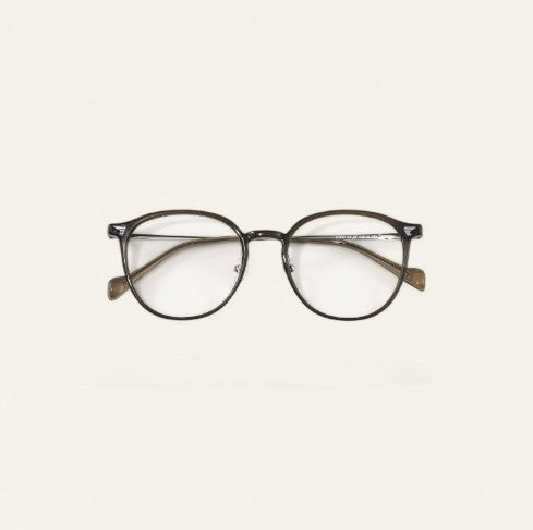 Driftward ultra light blue light blocking glasses with a transparent gray TR90 frame and round lenses.