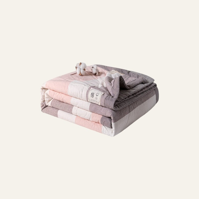 Driftward Cooling Summer Quilt in pastel pink, white, and grey stripes. Made from breathable cotton.